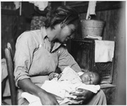 Near Buckeye, Maricopa County, Arizona. Migrant cotton picker and her baby. Lange, Dorothea